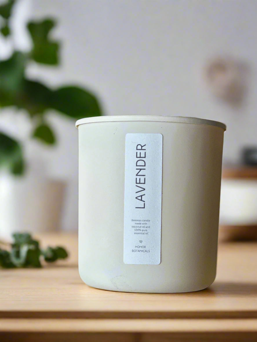 Lavender candle on a wooden surface with a blurred background