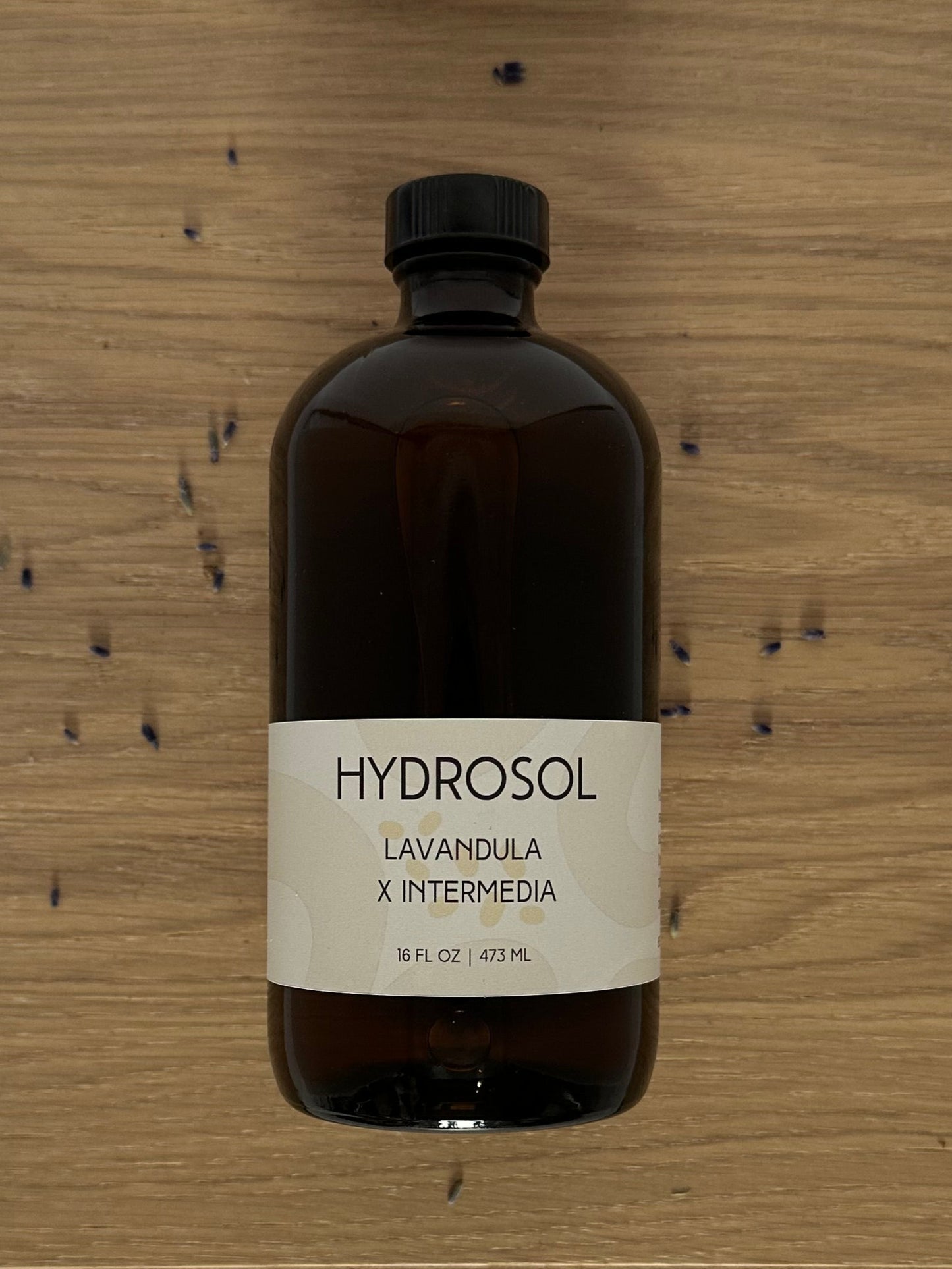 Brown bottle labeled 'HYDROSOL' on a wooden surface