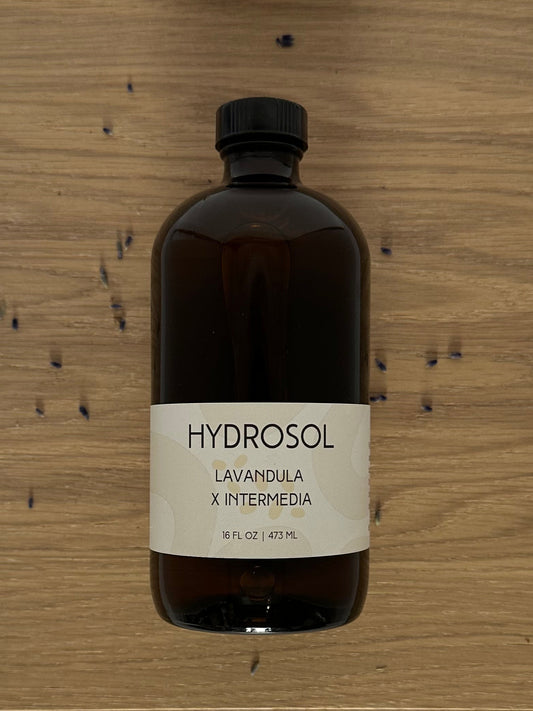 Brown bottle labeled 'HYDROSOL' on a wooden surface