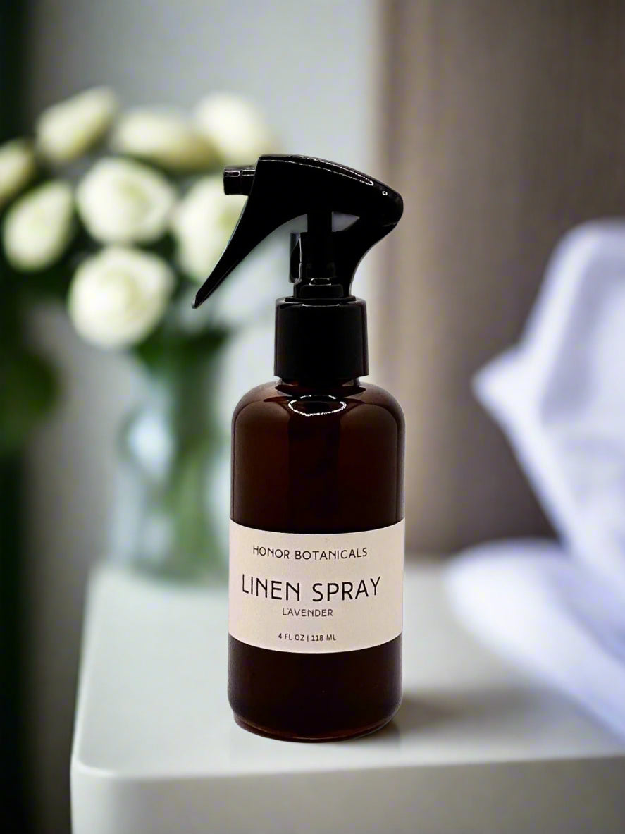 Linen spray bottle with lavender scent on a surface with a blurred background